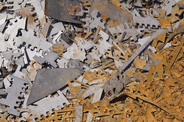 Assorted white and rusted metal brackets at a scrap metal recycling junkyard, Quebec, Canada, North America