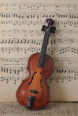 Toy violin in front of music sheet