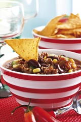Chili con carne, minced meat, kidney beans, corn, bell pepper, chili and a tortilla chip