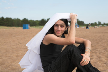 man with long hair on the beach