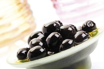 Black olives in a small glass bowl
