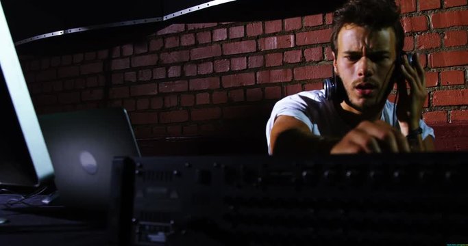Dj man using sound mixer console at a concert 