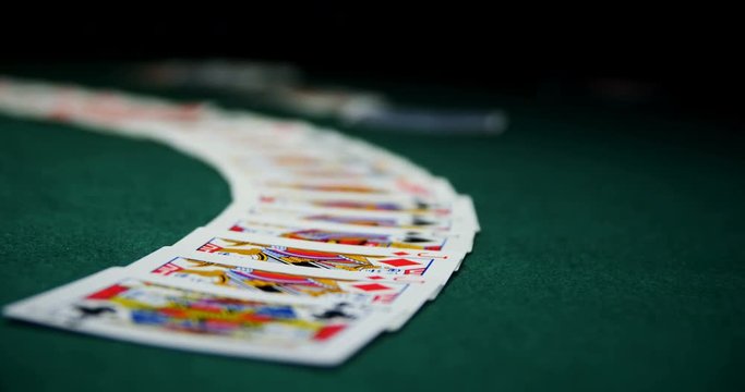 Playing cards arranged on poker table 