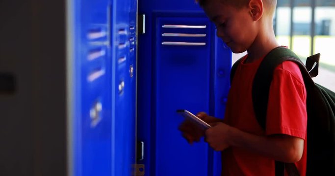Schoolboy using mobile phone in locker room 