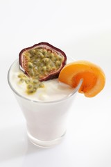 A glass of yogurt with apricot and a passionfruit