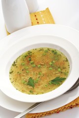 Oily vegetable soup with noodles, peas and carrots