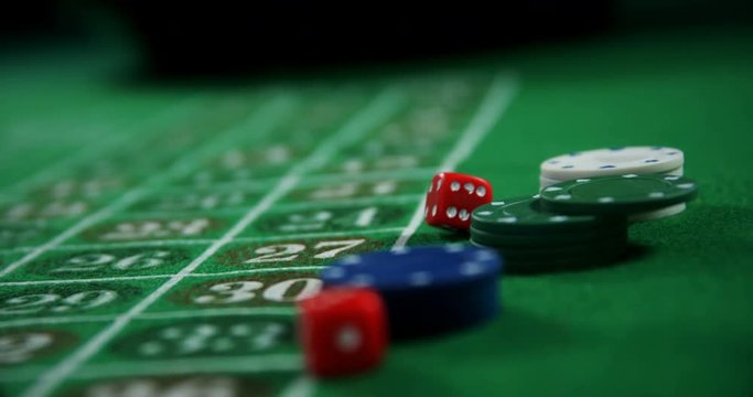 Casino chips and dice on roulette in casino 