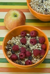 Fruit muesli with raspberries and an apple