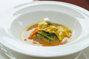 Tasty dumpling soup with vegetables and Pork