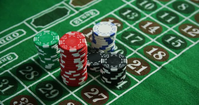 Casino chips on roulette on poker table 