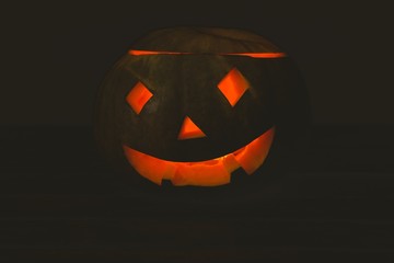 Fototapeta premium Jack o lantern glowing in darkroom