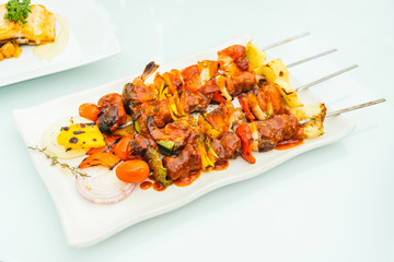 Grilled bbq meat stick in white plate