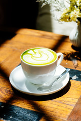 Green tea matcha latte in white cup