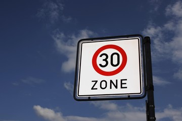 Traffic sign 30-zone it with blue sky and clouds