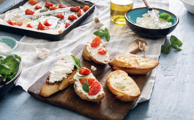 Ingredients for cooking Italian bruschetta on dark table
