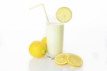 Lemon drinking yoghurt, lemon shake in a glass and lemons
