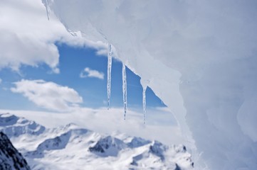 Icicles on snow drift in front of mountain landscape, Obergurgl, Hochgurgl, Oetztal Valley, Tyrol, Austria, Europe