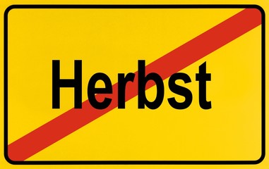 Town exit sign, German lettering Herbst, symbolic of end of autumn