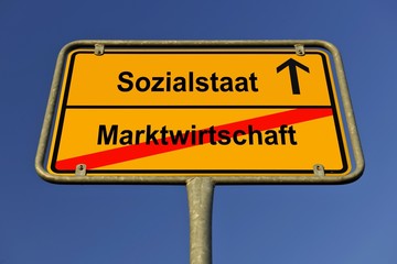 Obraz premium City limit sign, symbolic image for the way from a Marktwirtschaft to a Sozialstaat, German for going from a market economy to a welfare state