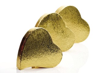 Small golden heart- shaped gift boxes