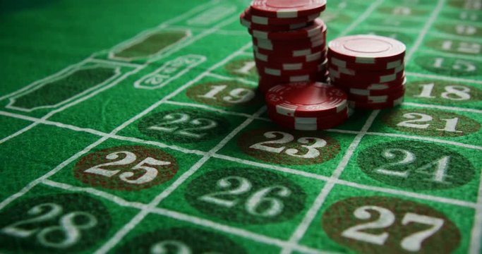 Casino chips on roulette on poker table 