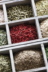 Spices in a case, pink pepper, peppercorns, cumin
