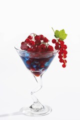 Frozen red currants in a drink