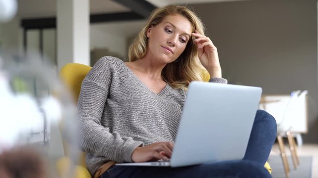 Woman at home connected on laptop computer