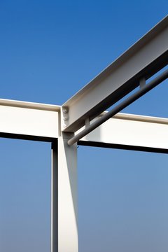 Steel beams of a warehouse against a blue sky, Berlin, Germany, Europe