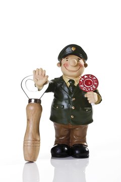 Miniature figure of a police man with a bottle opener