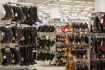 Women's and men's  shoes in the store.  Seasonal sale of shoes in the shopping center. 