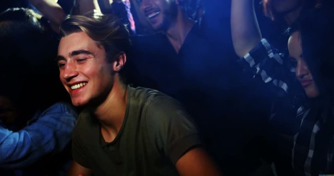 Young man dancing at a concert 