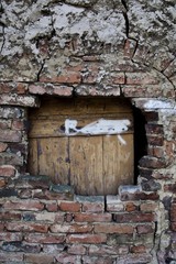 Wooden boards, a hole in a brick wall