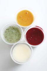 Tubs of yoghurt, kiwi, mango, strawberry and natural