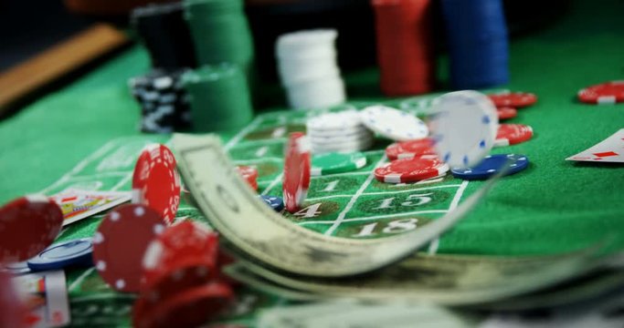 Roulette wheel, dollar, casino chips and playing cards on roulette 