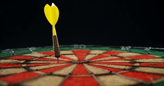 Arrow on dart against black background 
