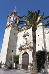 Main entrance with sandstone tower of the church Virgen de Regla in Chipiona, Andalusia, Spain, Europe