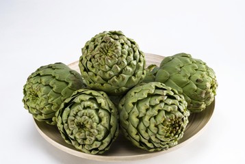 Artichokes (Cynara cardunculus) on a wooden bowl