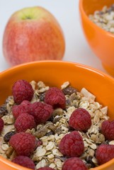 Fruit muesli with raspberries and an apple
