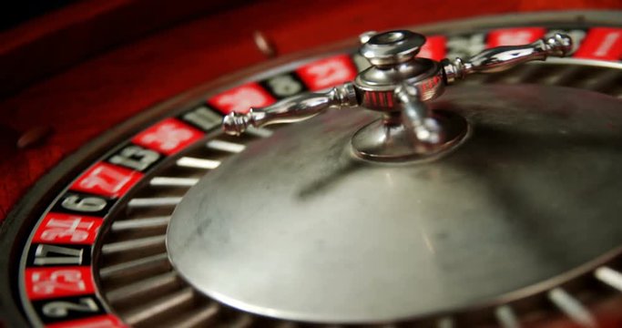 Close-up of spinning roulette wheel on poker table 