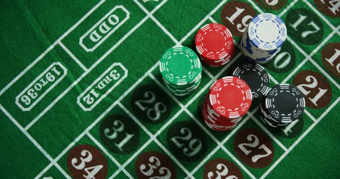 Casino chips on roulette on poker table 
