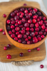 fresh cranberries on white wooden surface