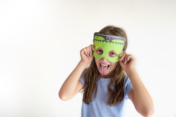 The girl plays the fool in a mask of the monster © Anastasiia