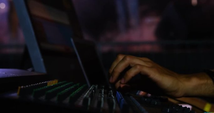 Dj man using sound mixer console at a concert 