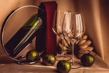 a glass of red wine and fruit