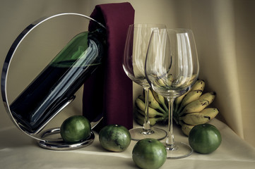 a glass of red wine and fruit