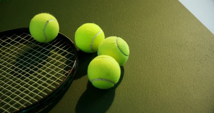 Racket and tennis ball in court 