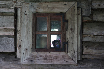 Fototapeta na wymiar Old window of a wooden building
