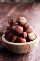 Hazelnut on wooden background. Tasty group of organic hazelnuts