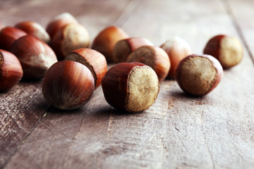 Hazelnut on wooden background. Tasty group of organic hazelnuts